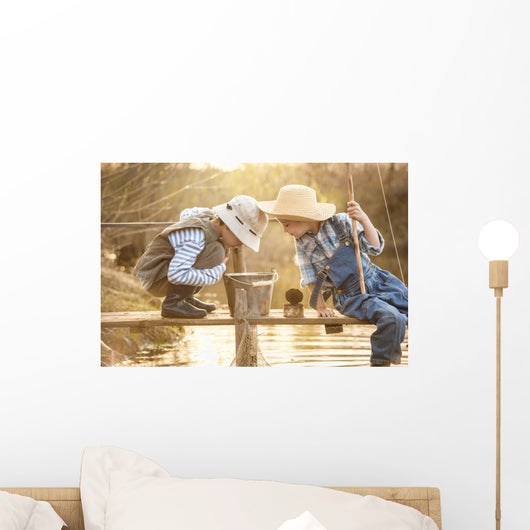 Boy fishes on a bridge on the lake Wall Mural
