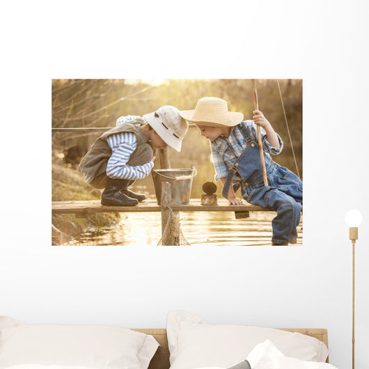 Boy fishes on a bridge on the lake Wall Mural