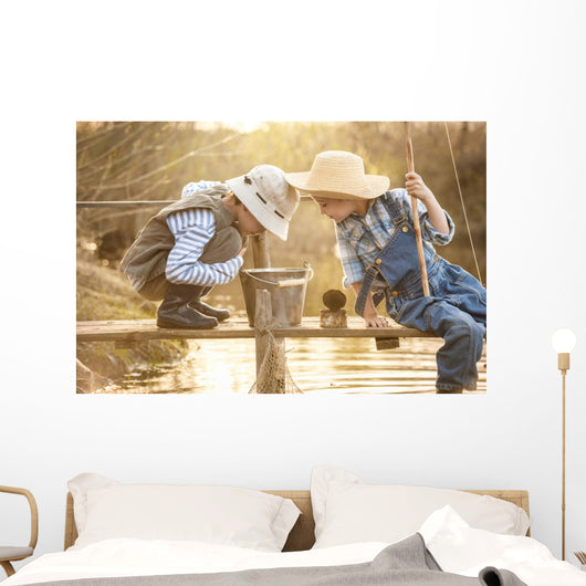 Boy fishes on a bridge on the lake Wall Mural