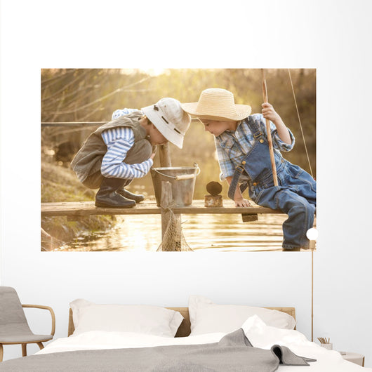 Boy fishes on a bridge on the lake Wall Mural