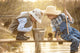 Boy fishes on a bridge on the lake Wall Mural