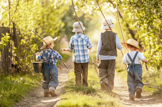 Boys go fishing with fishing rods on a rural street Wall Mural