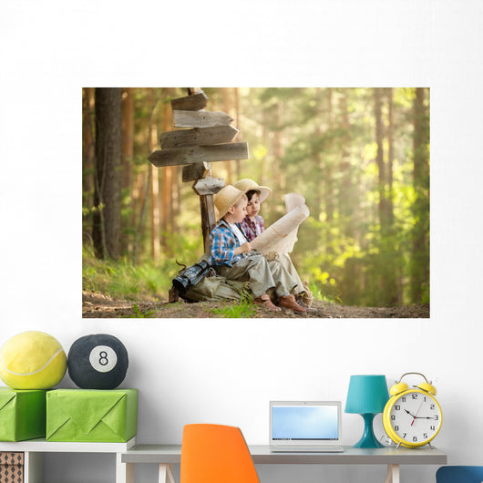 Boys on a forest road with backpacks Wall Mural