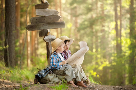 Boys on a forest road with backpacks Wall Mural