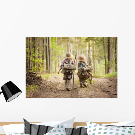 Boys on a forest road with backpacks Wall Mural
