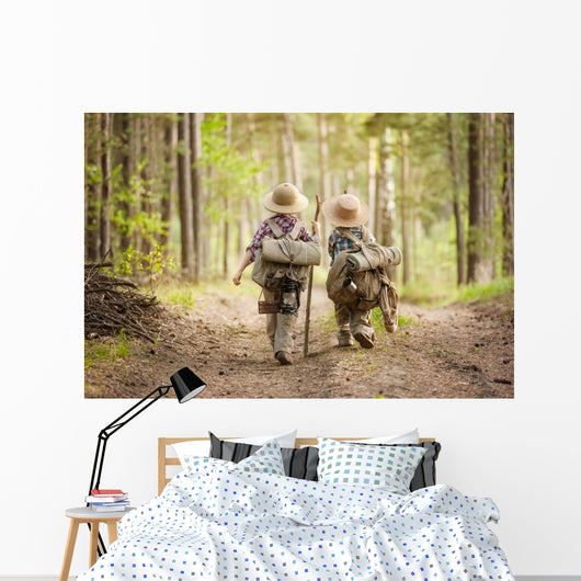 Boys on a forest road with backpacks Wall Mural