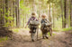 Boys on a forest road with backpacks Wall Mural