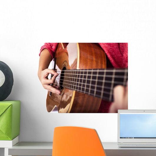 Closeup of girl´s hands playing acoustic quitar Wall Mural