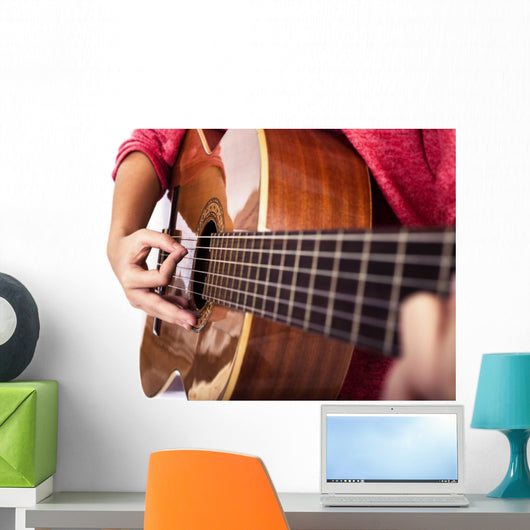 Closeup of girl´s hands playing acoustic quitar Wall Mural
