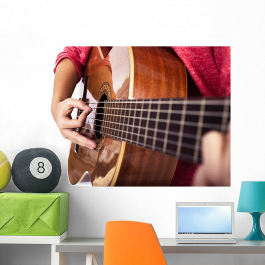 Closeup of girl´s hands playing acoustic quitar Wall Mural