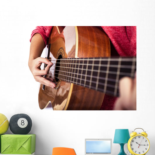 Closeup of girl´s hands playing acoustic quitar Wall Mural