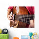 Closeup of girl´s hands playing acoustic quitar Wall Mural