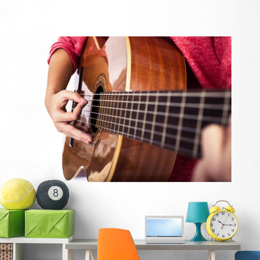 Closeup of girl´s hands playing acoustic quitar Wall Mural