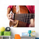 Closeup of girl´s hands playing acoustic quitar Wall Mural