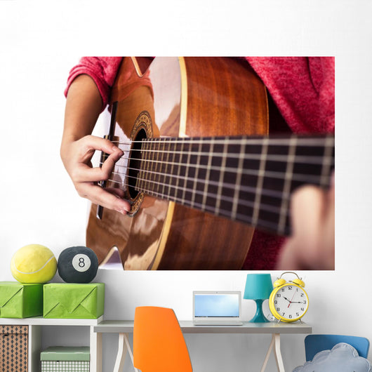 Closeup of girl´s hands playing acoustic quitar Wall Mural