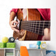 Closeup of girl´s hands playing acoustic quitar Wall Mural