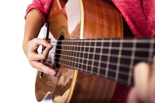 Closeup of girl´s hands playing acoustic quitar Wall Mural