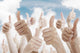 Many people holding their thumbs up Wall Mural