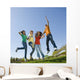 Happy teens jump in air. Wall Mural