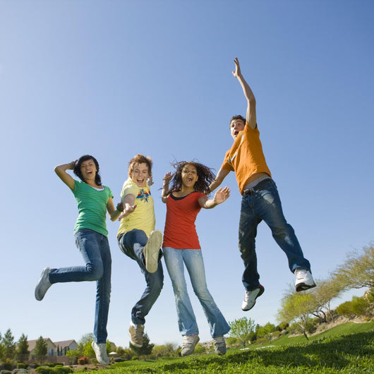 Happy teens jump in air. Wall Mural