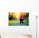 woman runner running at tropical park Wall Mural