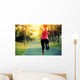 woman runner running at tropical park Wall Mural