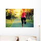 woman runner running at tropical park Wall Mural