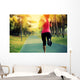 woman runner running at tropical park Wall Mural
