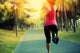 woman runner running at tropical park Wall Mural