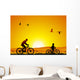 Mountain bike at sunset with child Wall Mural