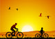 Mountain bike at sunset with child Wall Mural