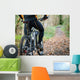 Cyclist standing in front of a path of the forest Wall Mural
