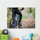 Cyclist standing in front of a path of the forest Wall Mural