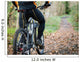 Cyclist standing in front of a path of the forest Wall Mural