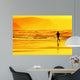 person running on beach at sunset Wall Mural
