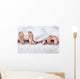 Feet of a family sticking out from the white quilt Wall Mural