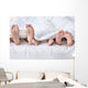 Feet of a family sticking out from the white quilt Wall Mural