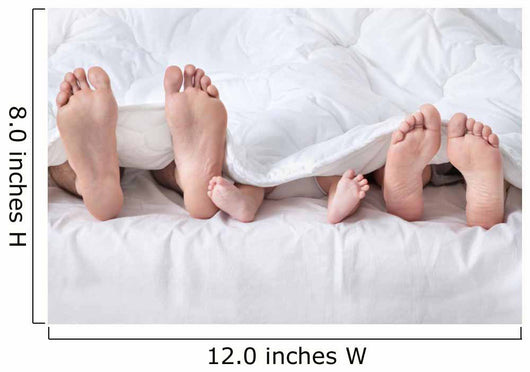 Feet of a family sticking out from the white quilt Wall Mural