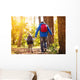 Father and son walking in autumn forest Wall Mural