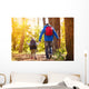 Father and son walking in autumn forest Wall Mural