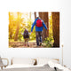 Father and son walking in autumn forest Wall Mural