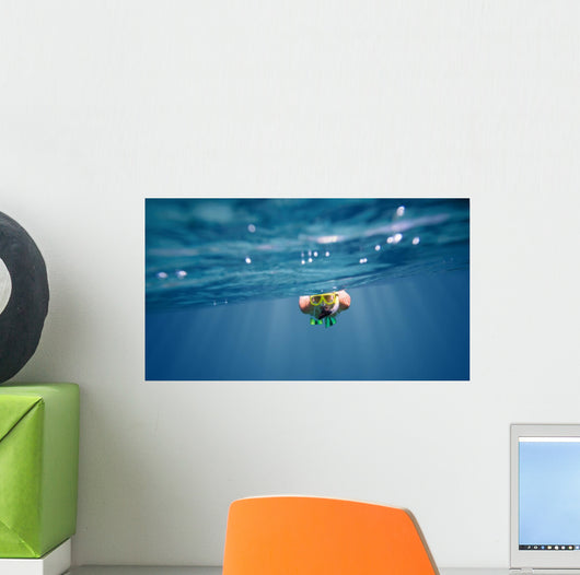 Underwater portrait of a woman snorkeling Wall Mural