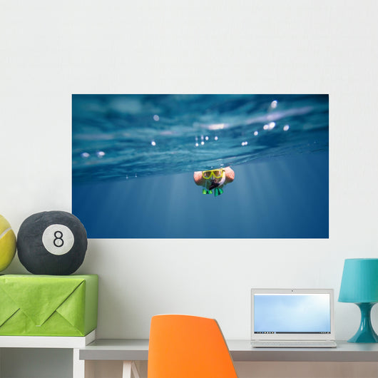 Underwater portrait of a woman snorkeling Wall Mural