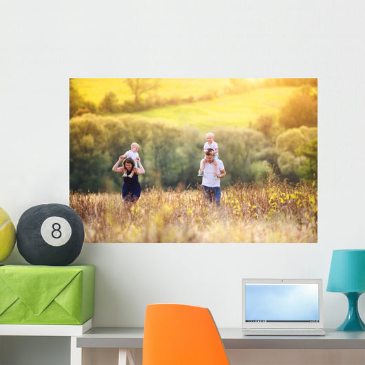 Family enjoying life together outside Wall Mural