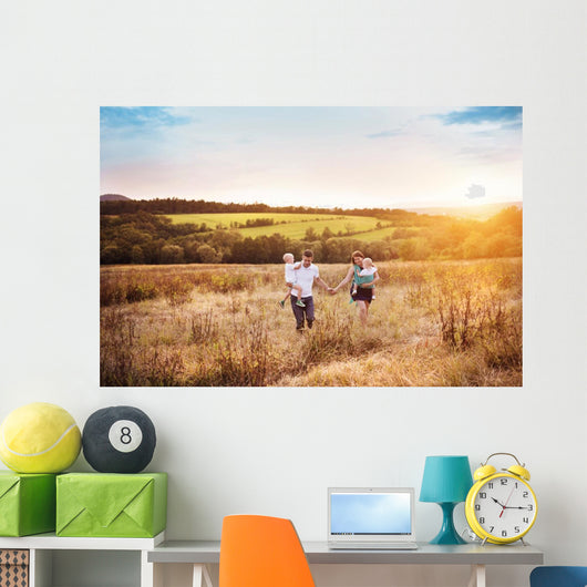 Family enjoying life together outside Wall Mural