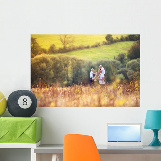 Family enjoying life together outside Wall Mural