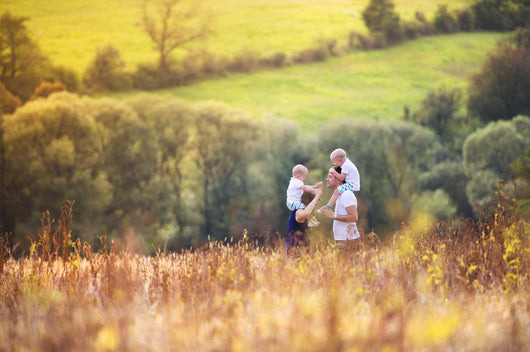 Family enjoying life together outside Wall Mural