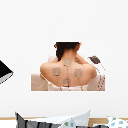Asian woman is doing massage of electrical -stimulation ( TENs ) Wall Mural