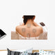 Asian woman is doing massage of electrical -stimulation ( TENs ) Wall Mural