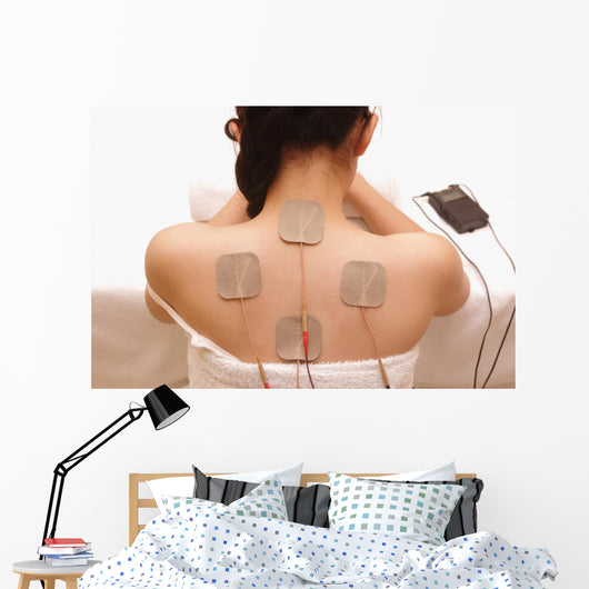 Asian woman is doing massage of electrical -stimulation ( TENs ) Wall Mural